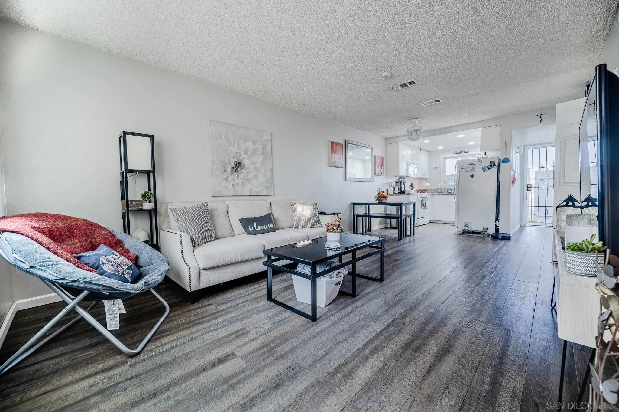 5140 North River Road, Unit F Oceanside, CA 92057 - Photo 5 of 39 a living room with furniture and a wooden floor