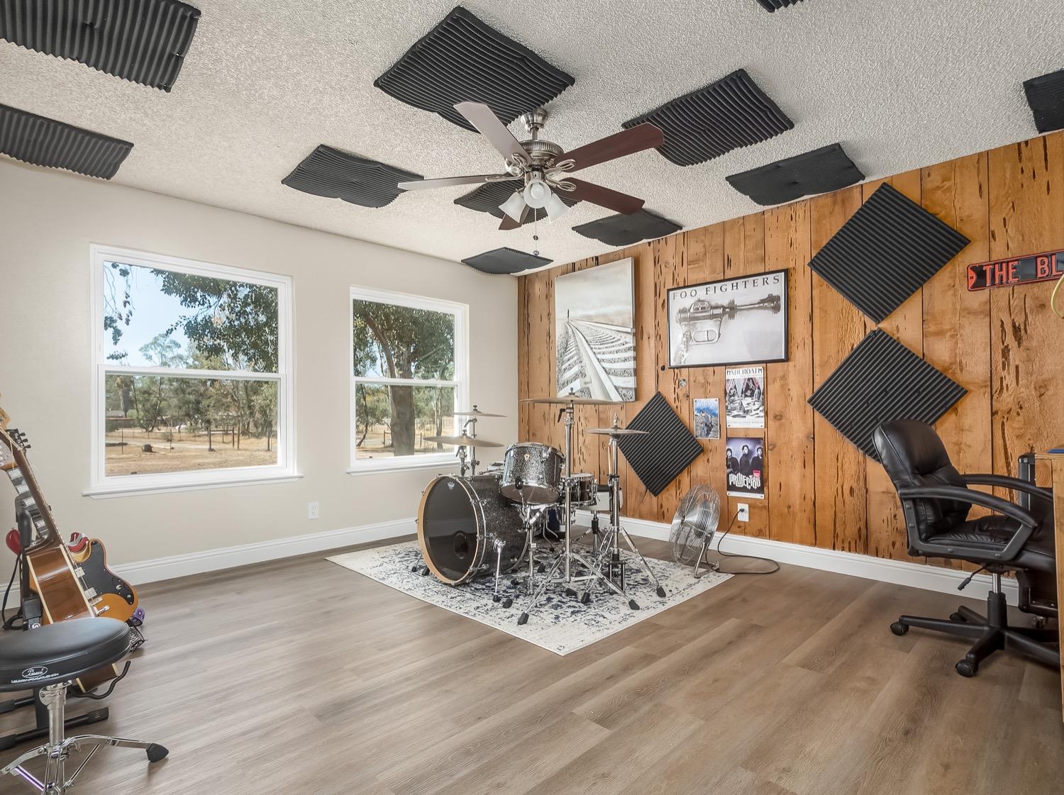 16181 Monreal Road Madera, CA 93636 - Photo 15 of 40 a living room with furniture a window and gym equipment