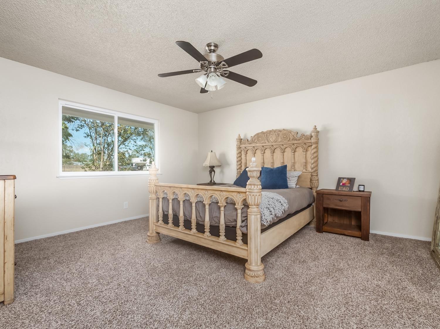 16181 Monreal Road Madera, CA 93636 - Photo 21 of 40 a bedroom with a bed and window