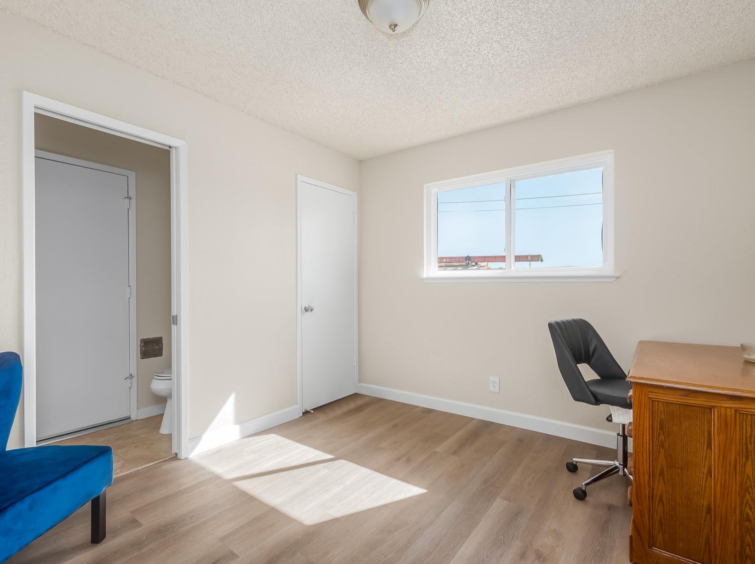 16181 Monreal Road Madera, CA 93636 - Photo 26 of 40 a view of a workspace with furniture and wooden floor