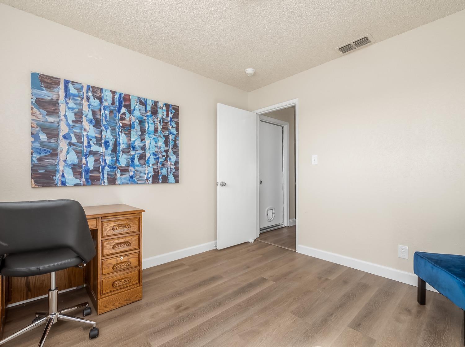 16181 Monreal Road Madera, CA 93636 - Photo 27 of 40 a view of room with furniture and wooden floor