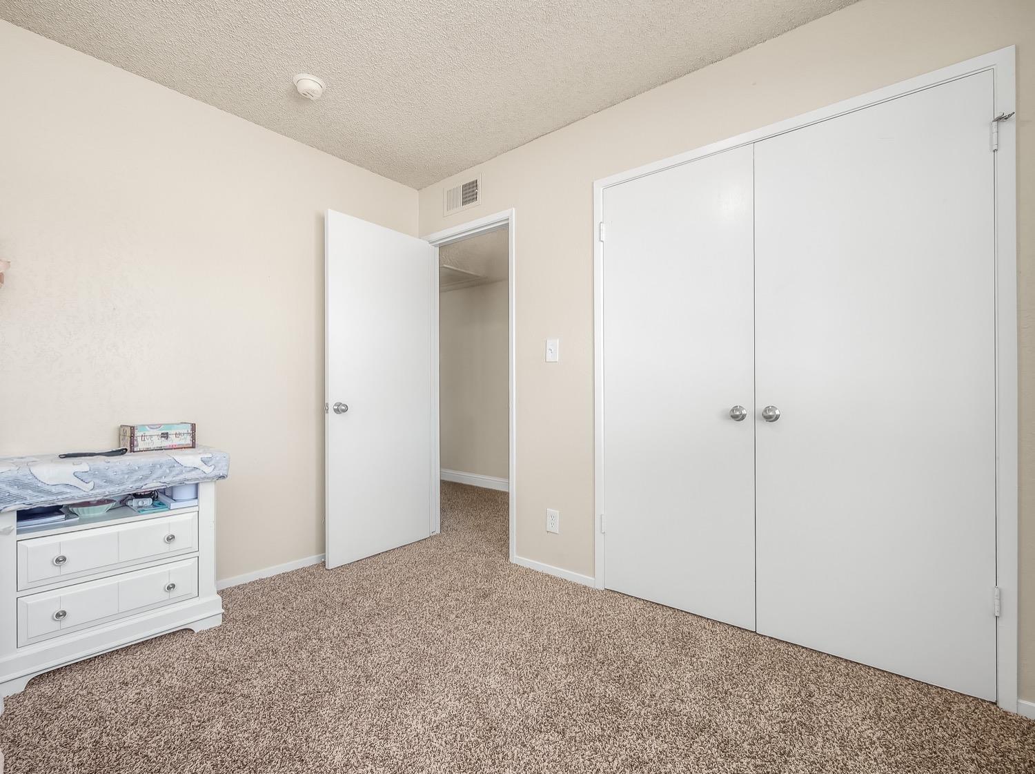 16181 Monreal Road Madera, CA 93636 - Photo 30 of 40 a view of a hallway to closet and dresser