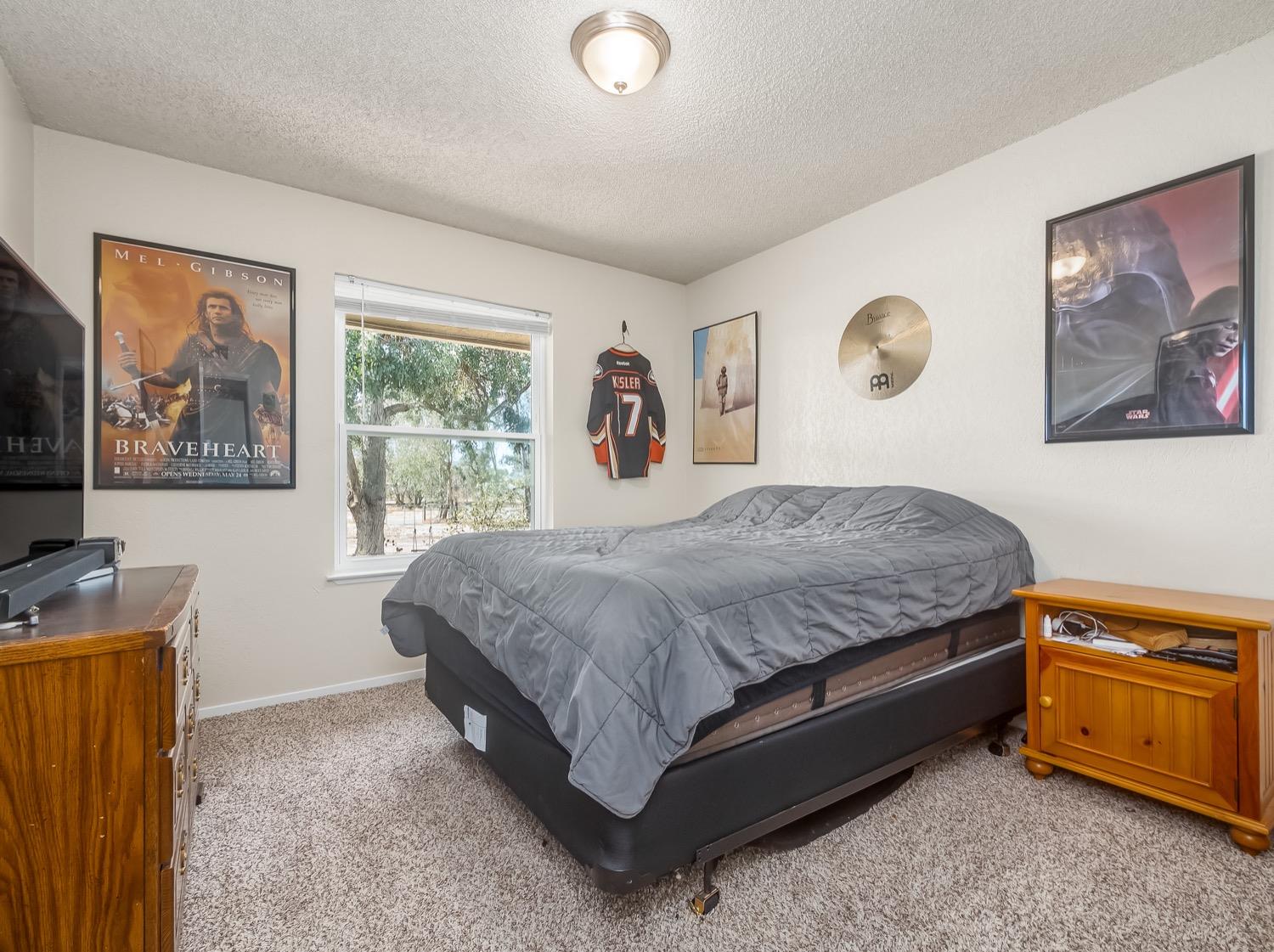 16181 Monreal Road Madera, CA 93636 - Photo 31 of 40 a bedroom with a bed and a desk