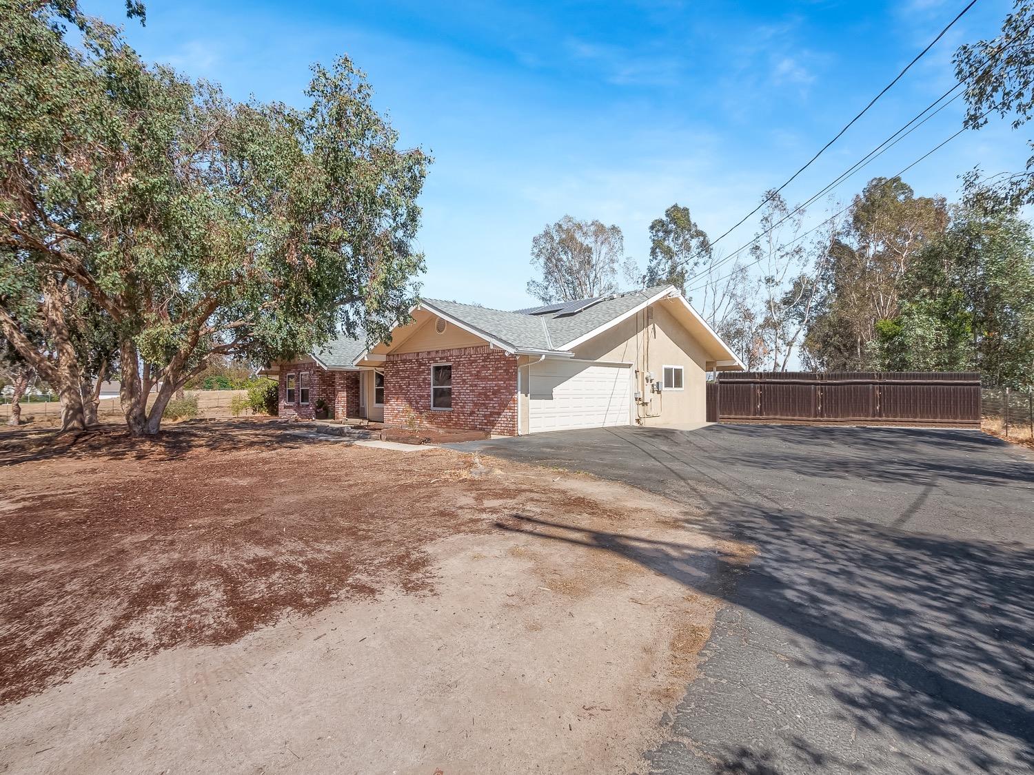 16181 Monreal Road Madera, CA 93636 - Photo 34 of 40 a view of house with trees in the background
