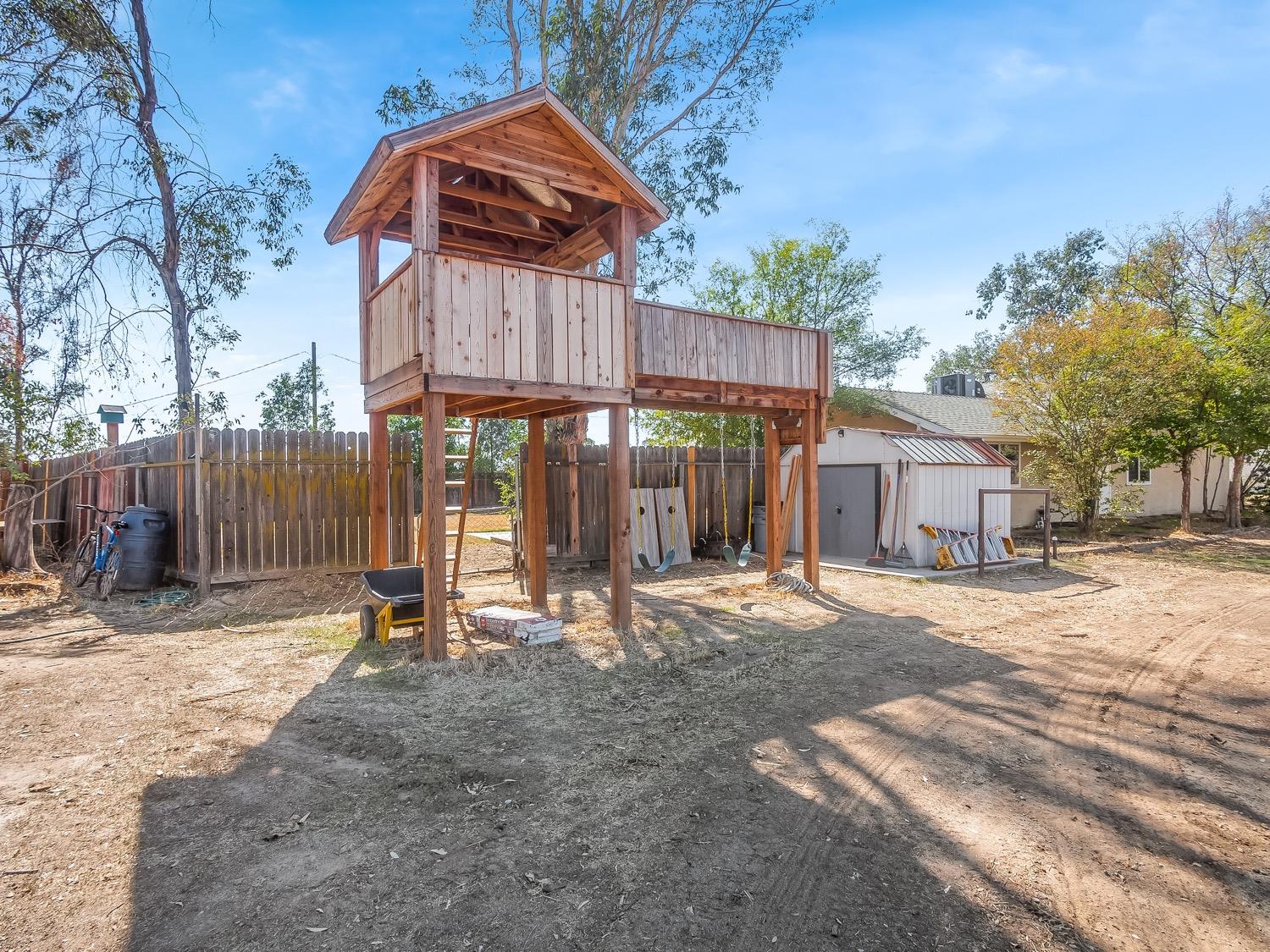16181 Monreal Road Madera, CA 93636 - Photo 35 of 40 a backyard of a house with barbeque oven table and chairs