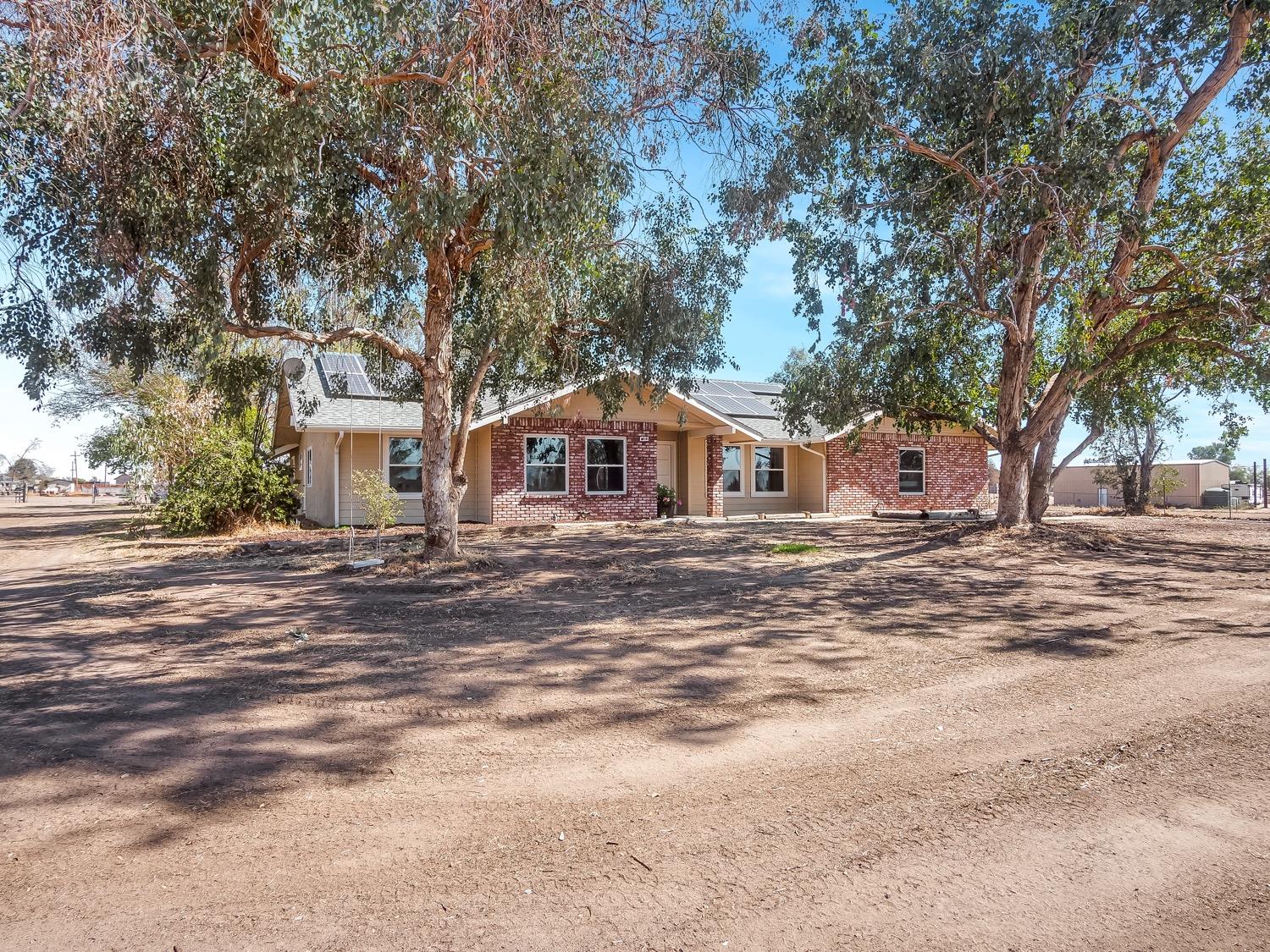 16181 Monreal Road Madera, CA 93636 - Photo 39 of 40 a front view of a house with a yard