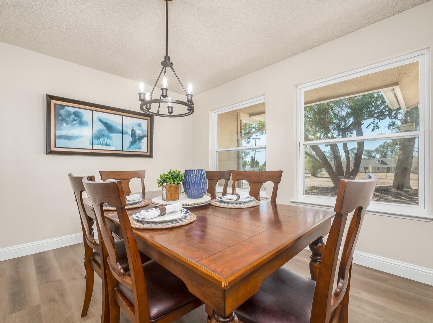 16181 Monreal Road Madera, CA 93636 - Photo 5 of 40 a view of a dining room with furniture window and wooden floor