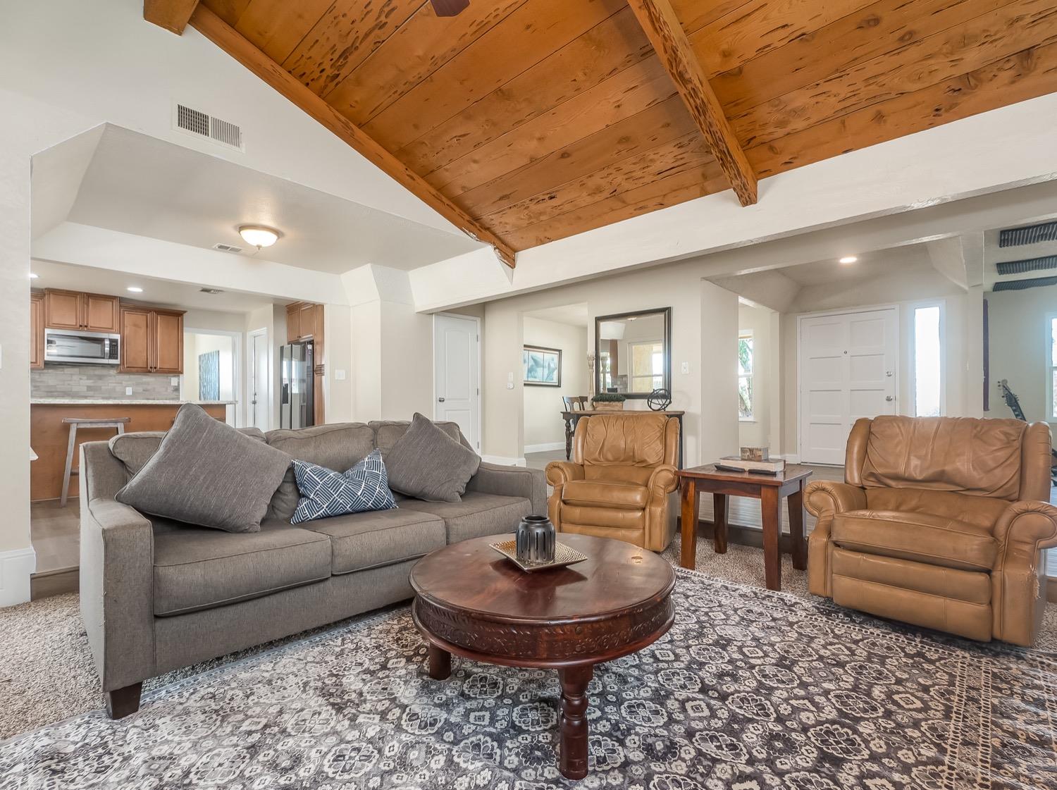16181 Monreal Road Madera, CA 93636 - Photo 7 of 40 a living room with furniture and a dining room