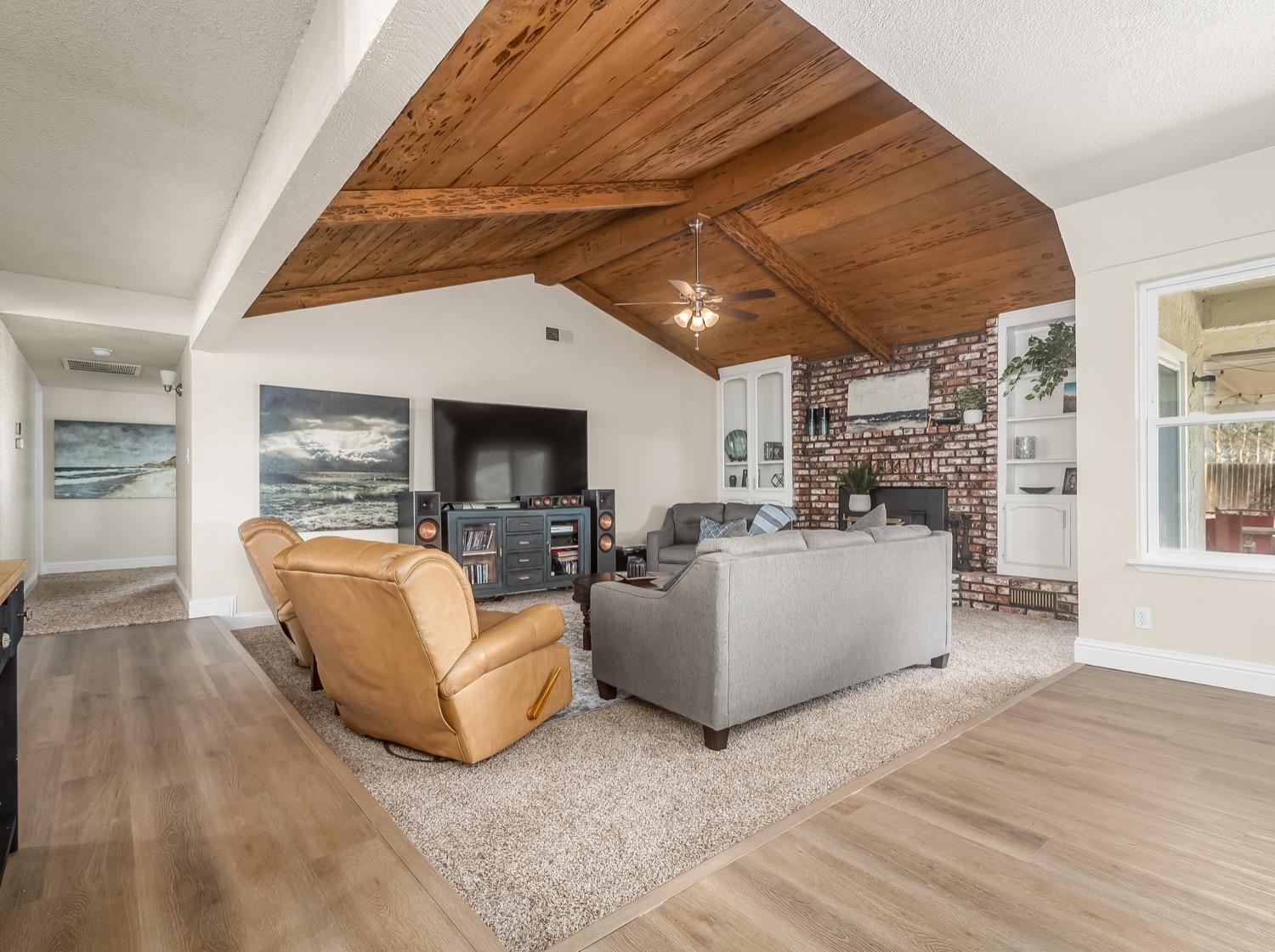 16181 Monreal Road Madera, CA 93636 - Photo 10 of 40 a living room with fireplace furniture and a wooden floor