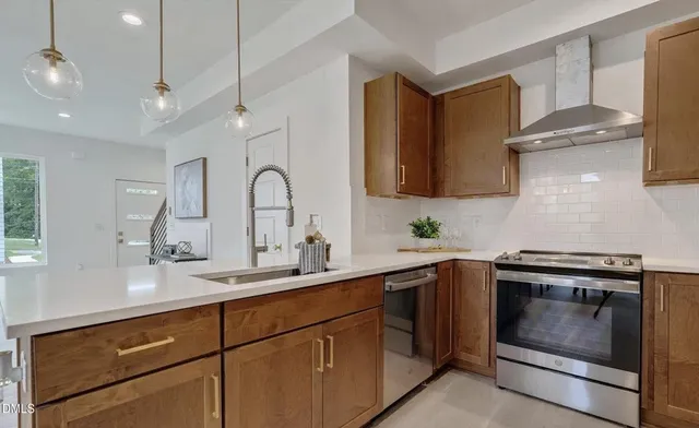 a kitchen with a sink stove and cabinets