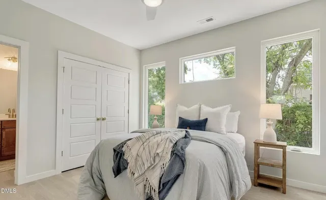 a bedroom with bed and a window