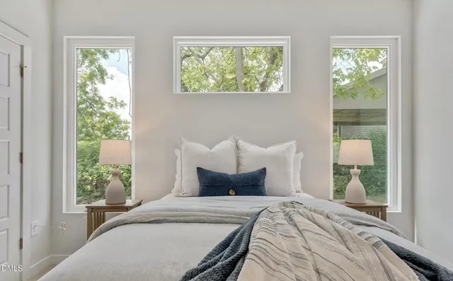 a bedroom with bed and window
