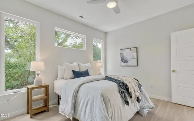 a bedroom with bed and a window