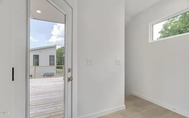 a bathroom with a glass door shower and a sink