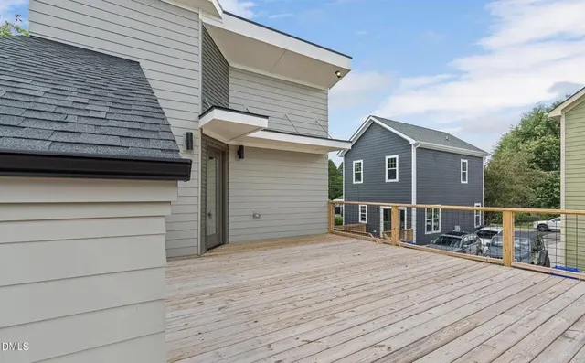 a view of a house with a wooden deck