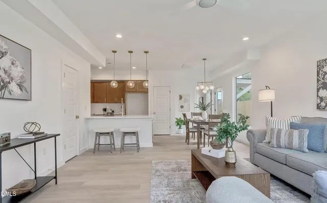 a living room with furniture and a chandelier