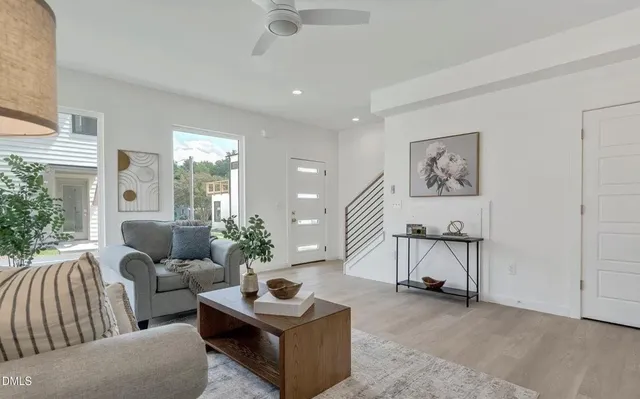 a living room with furniture and a potted plant