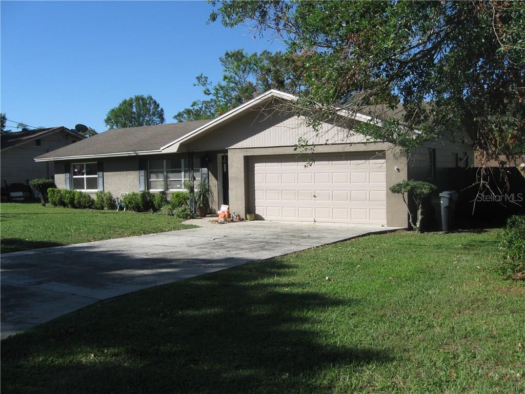 161 Whitman Road Winter Haven, FL 33884 - Photo 1 of 1 a front view of a house with a yard and garage