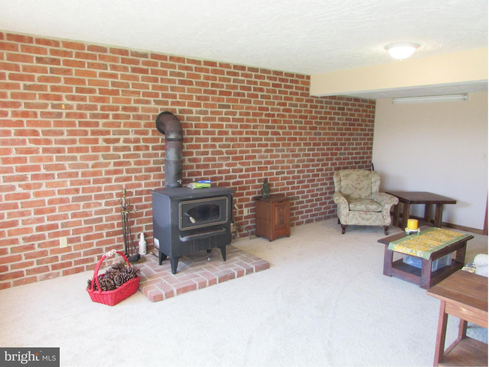 193 Bell Road Westminster, MD 21158 - Photo 22 of 30 Den with woodstove