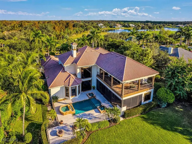 an aerial view of a house with a garden and lake view