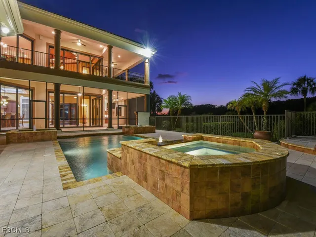 a view of a swimming pool with a chair and tables