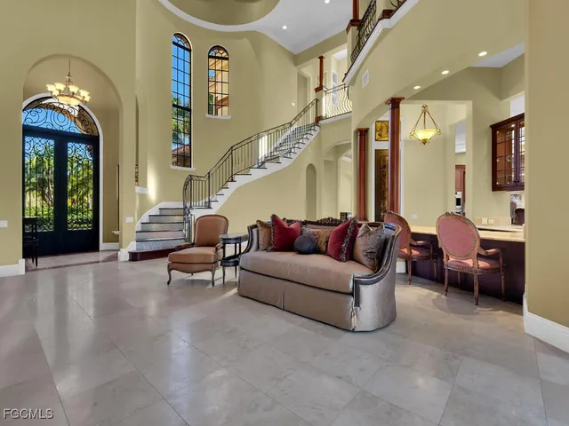 a living room with furniture and a chandelier