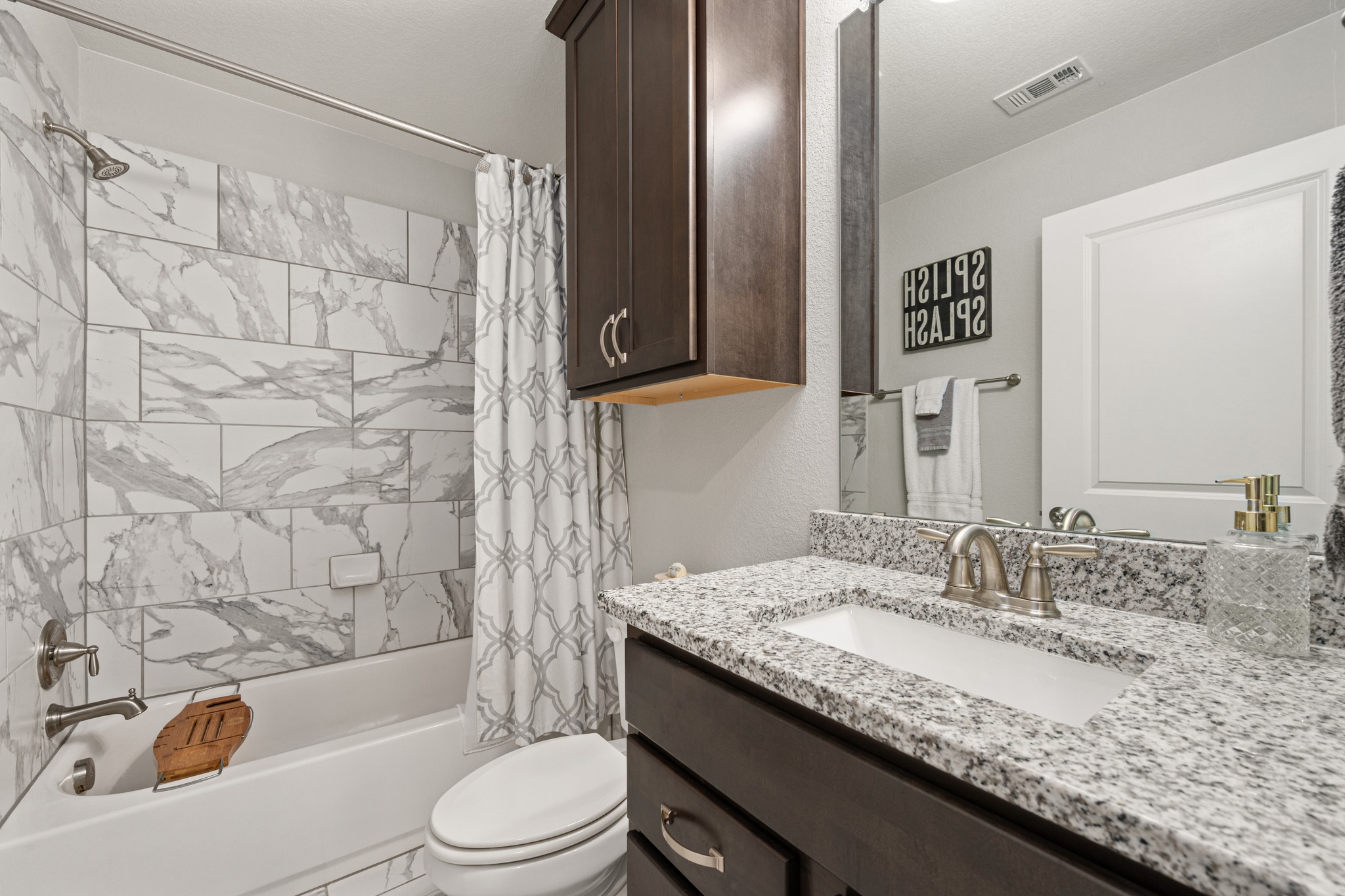 372 Adams Street Georgetown, TX 78628 - Photo 23 of 33 a bathroom with a granite countertop sink toilet and shower