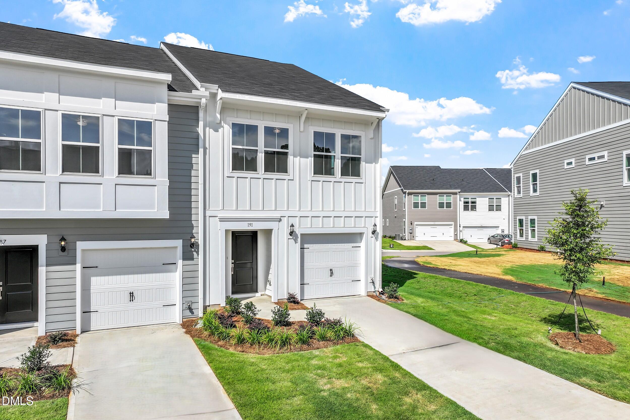 a front view of a house with swimming pool outdoor seating and yard