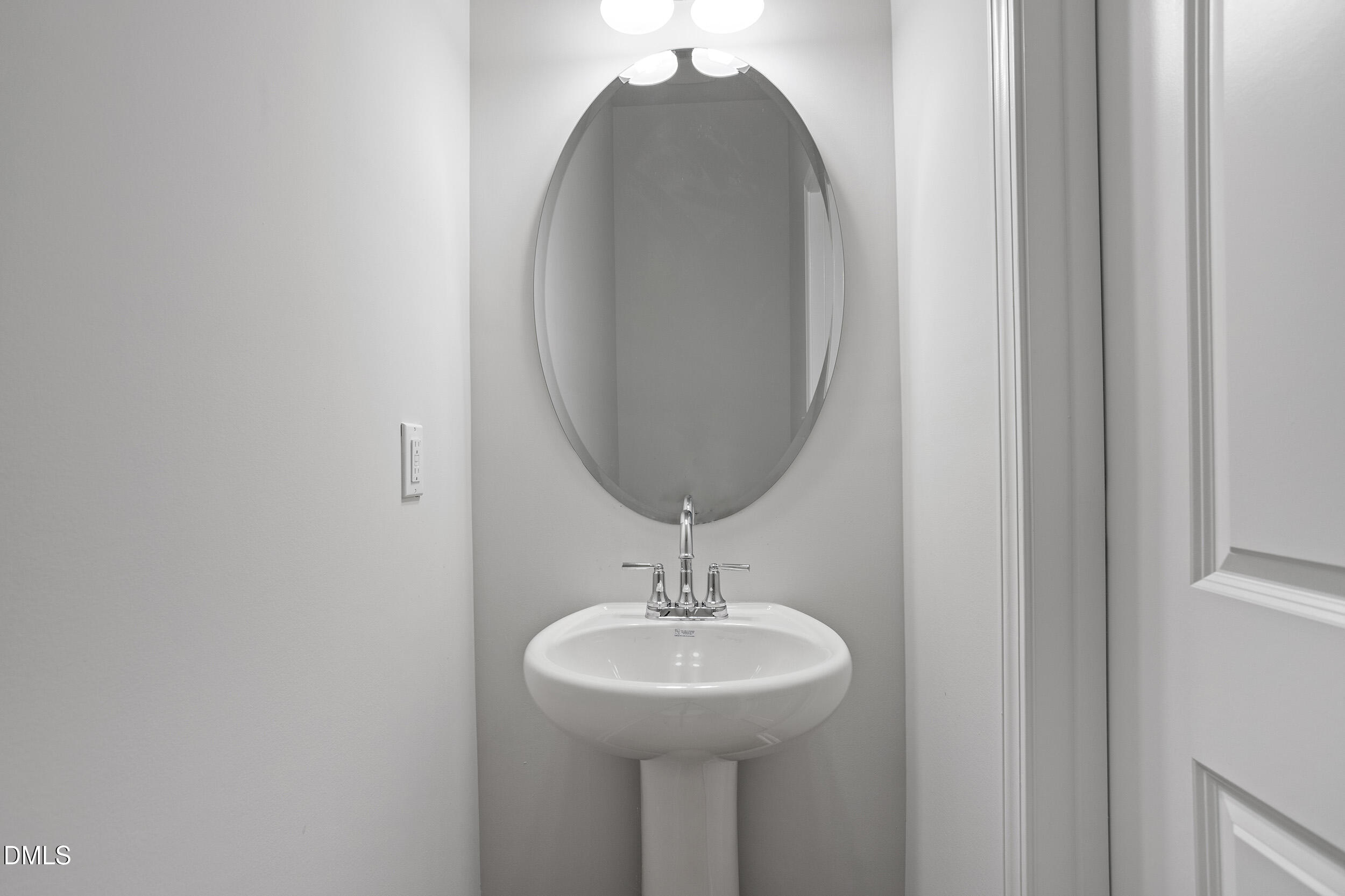 191 Powell Townes Way, Unit 319 Raleigh, NC 27603 - Photo 19 of 50 a bathroom with a sink and a mirror