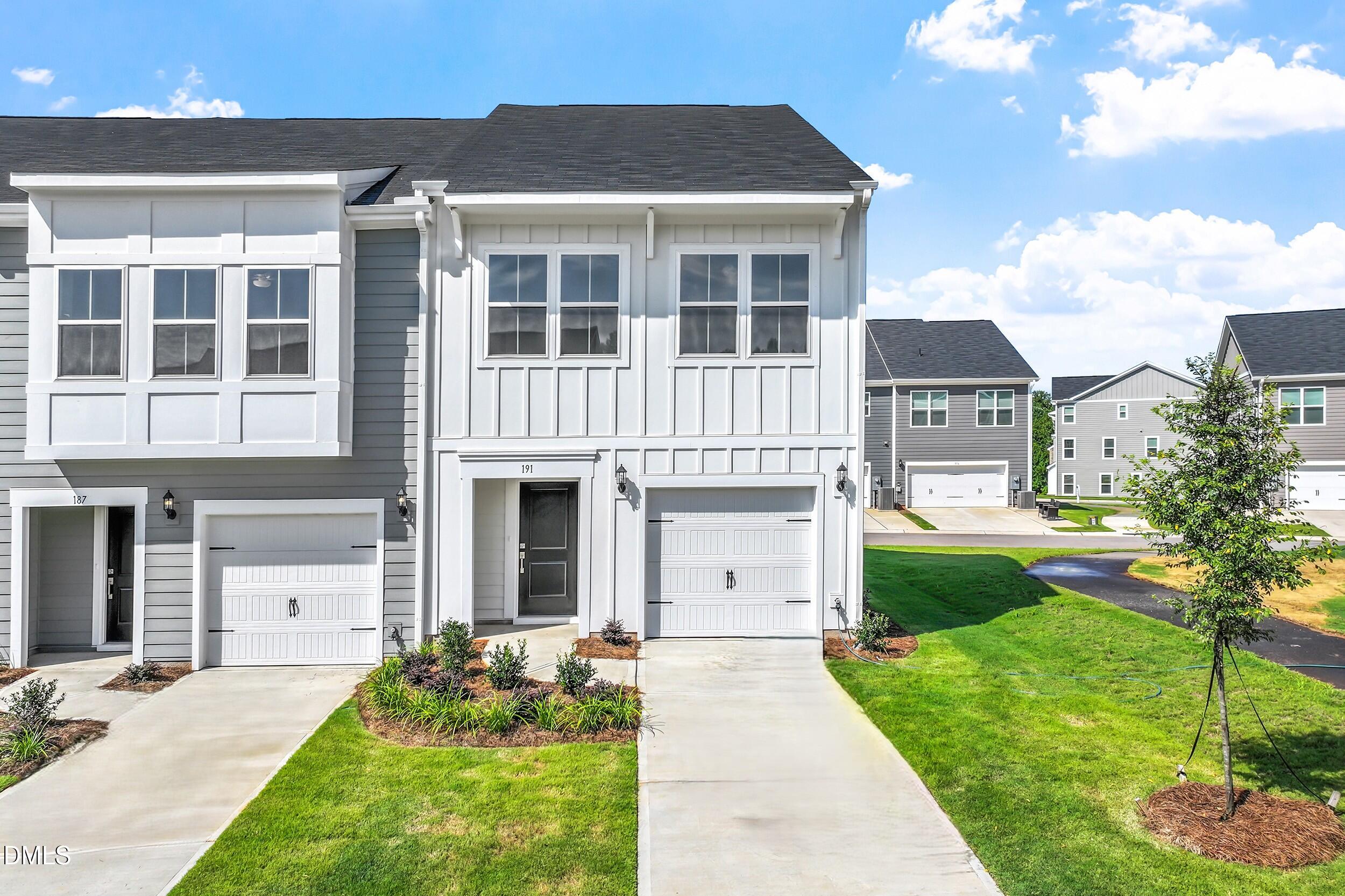 191 Powell Townes Way, Unit 319 Raleigh, NC 27603 - Photo 2 of 50 a front view of a house with a yard