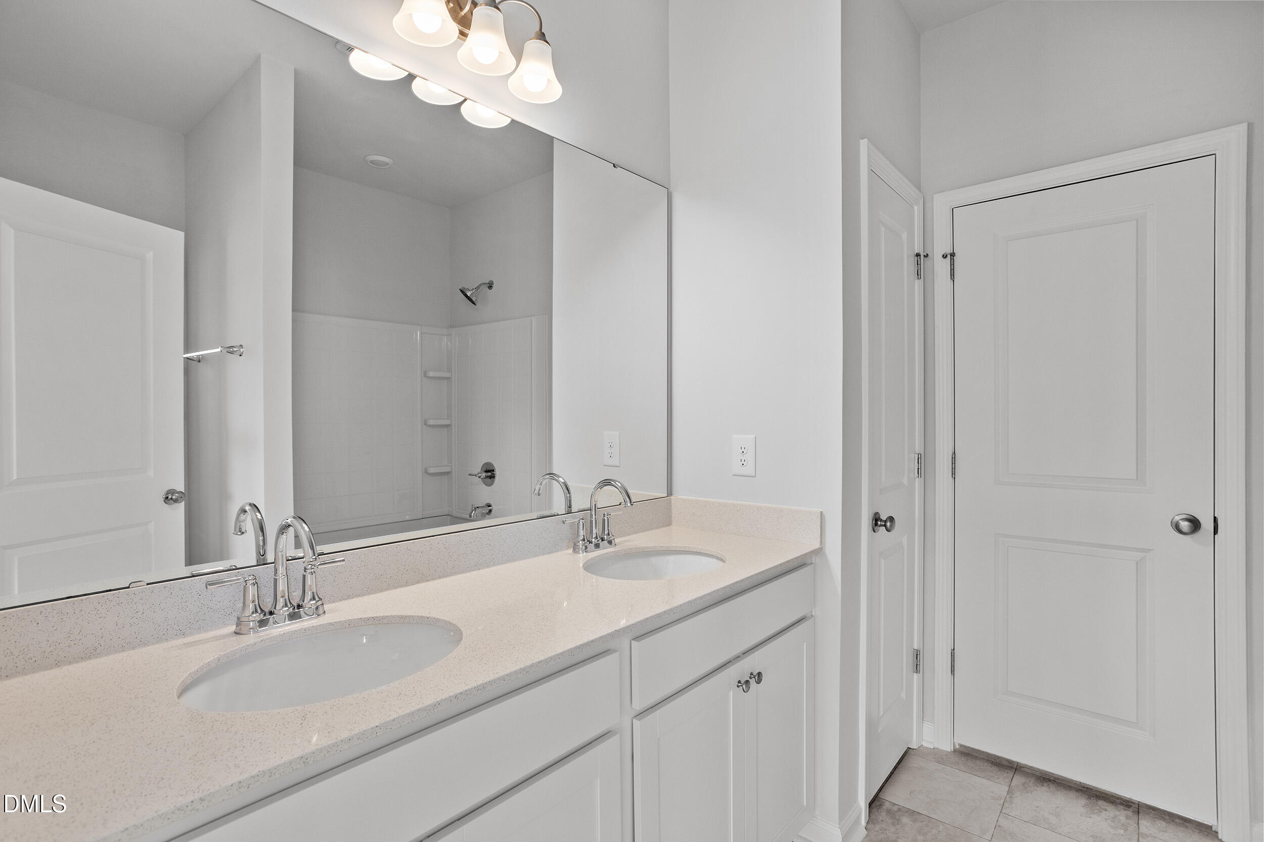191 Powell Townes Way, Unit 319 Raleigh, NC 27603 - Photo 23 of 50 a bathroom with double vanity sinks and a mirror