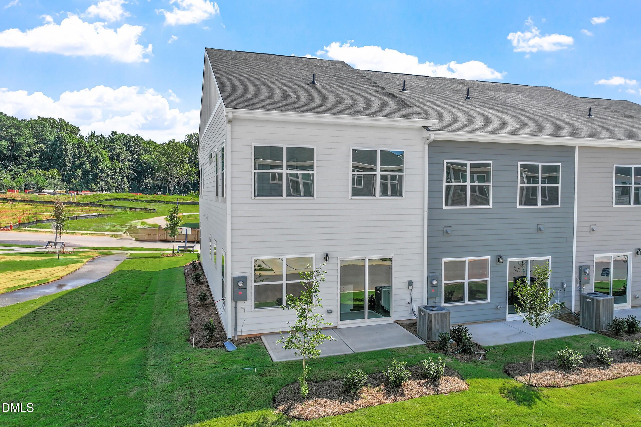 191 Powell Townes Way, Unit 319 Raleigh, NC 27603 - Photo 30 of 50 a front view of a house with garden and swimming pool