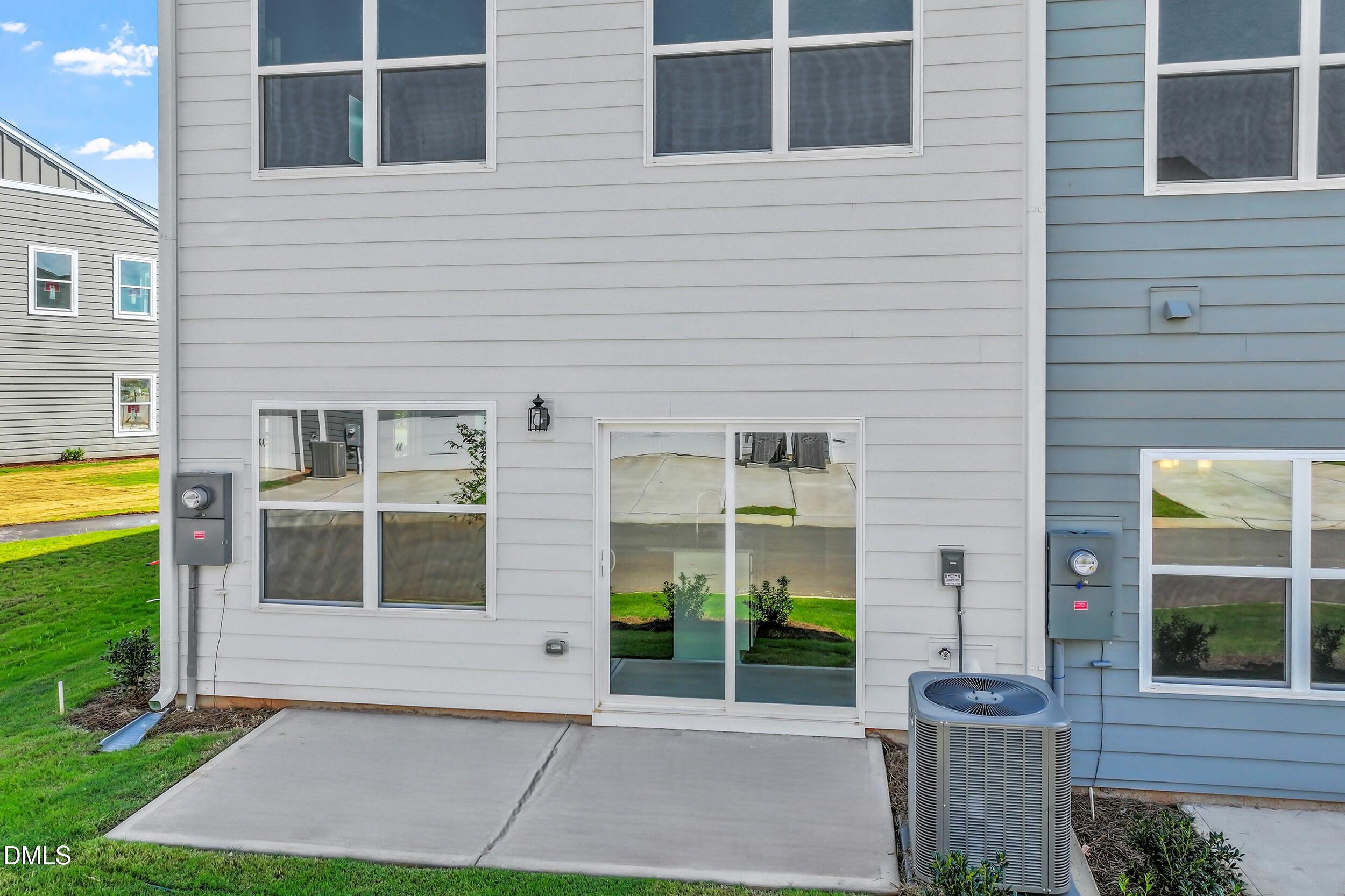 191 Powell Townes Way, Unit 319 Raleigh, NC 27603 - Photo 31 of 50 a front view of a house with a garden