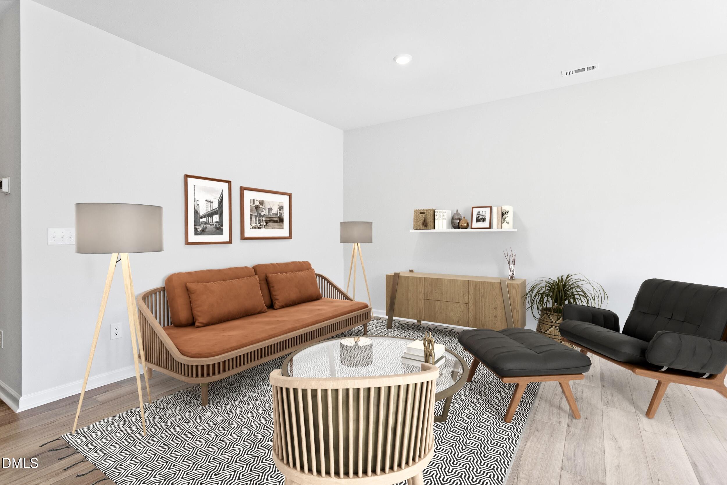 191 Powell Townes Way, Unit 319 Raleigh, NC 27603 - Photo 32 of 50 a living room with furniture and a lamp