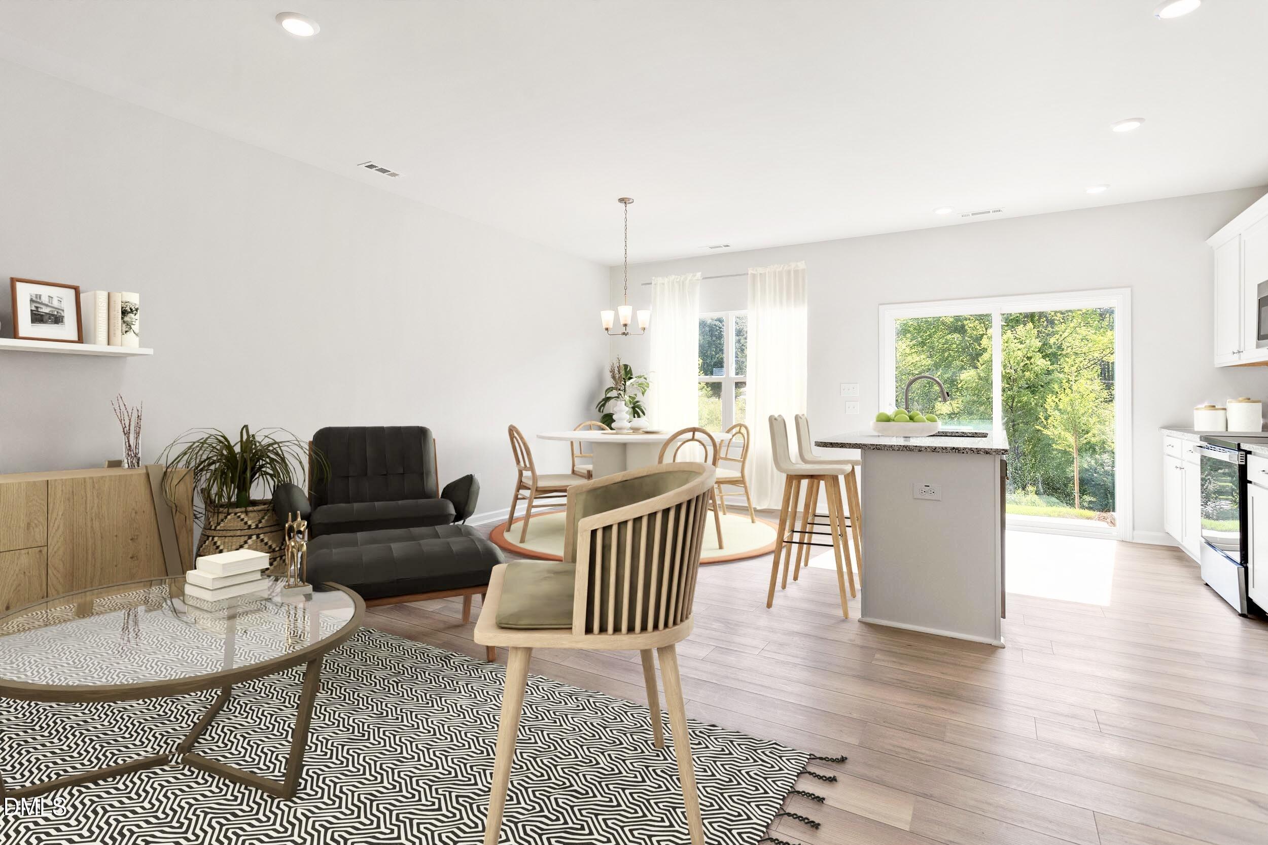 191 Powell Townes Way, Unit 319 Raleigh, NC 27603 - Photo 33 of 50 a living room with furniture and a wooden floor