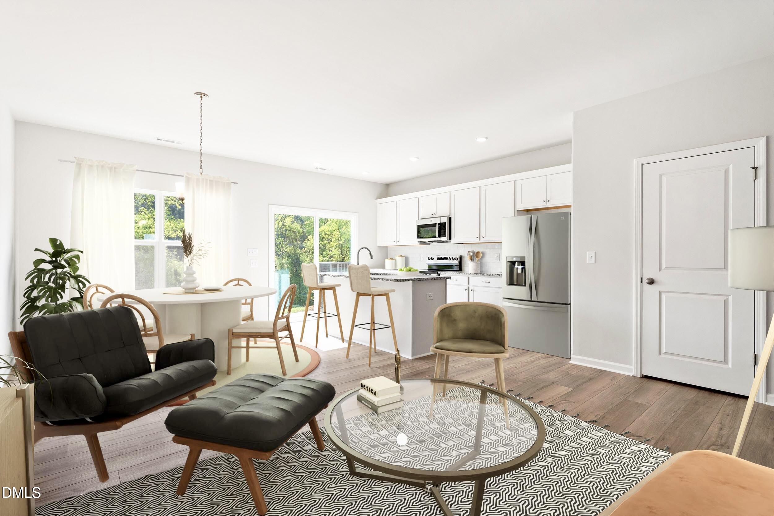 191 Powell Townes Way, Unit 319 Raleigh, NC 27603 - Photo 34 of 50 a kitchen with stainless steel appliances kitchen island granite countertop a table and chairs