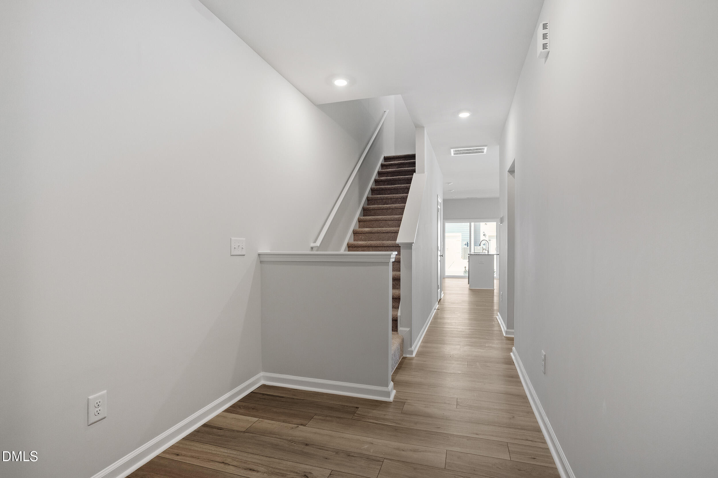 191 Powell Townes Way, Unit 319 Raleigh, NC 27603 - Photo 4 of 50 a view of a hallway with wooden floor