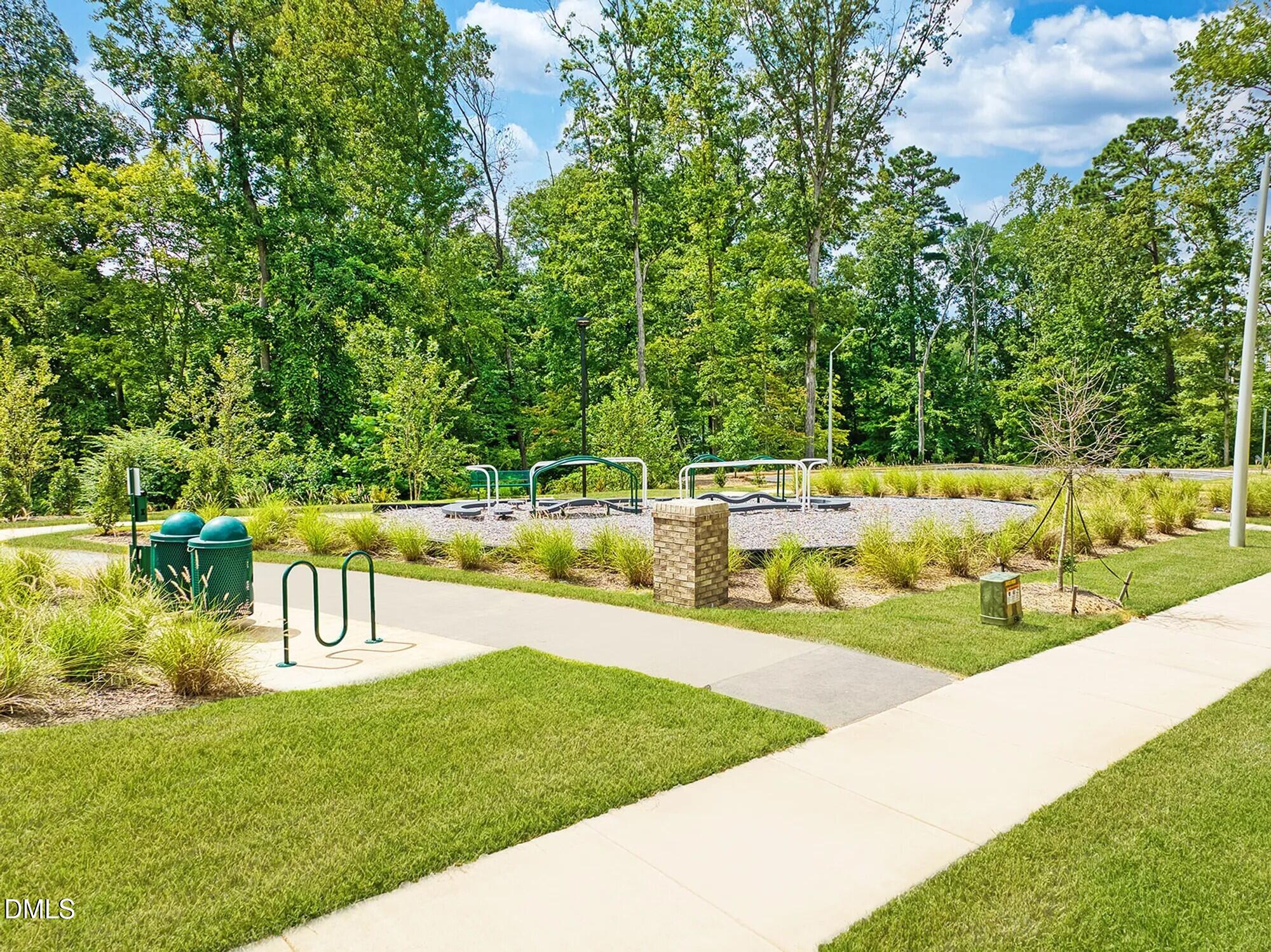191 Powell Townes Way, Unit 319 Raleigh, NC 27603 - Photo 45 of 50 a view of a swimming pool with a garden and trees