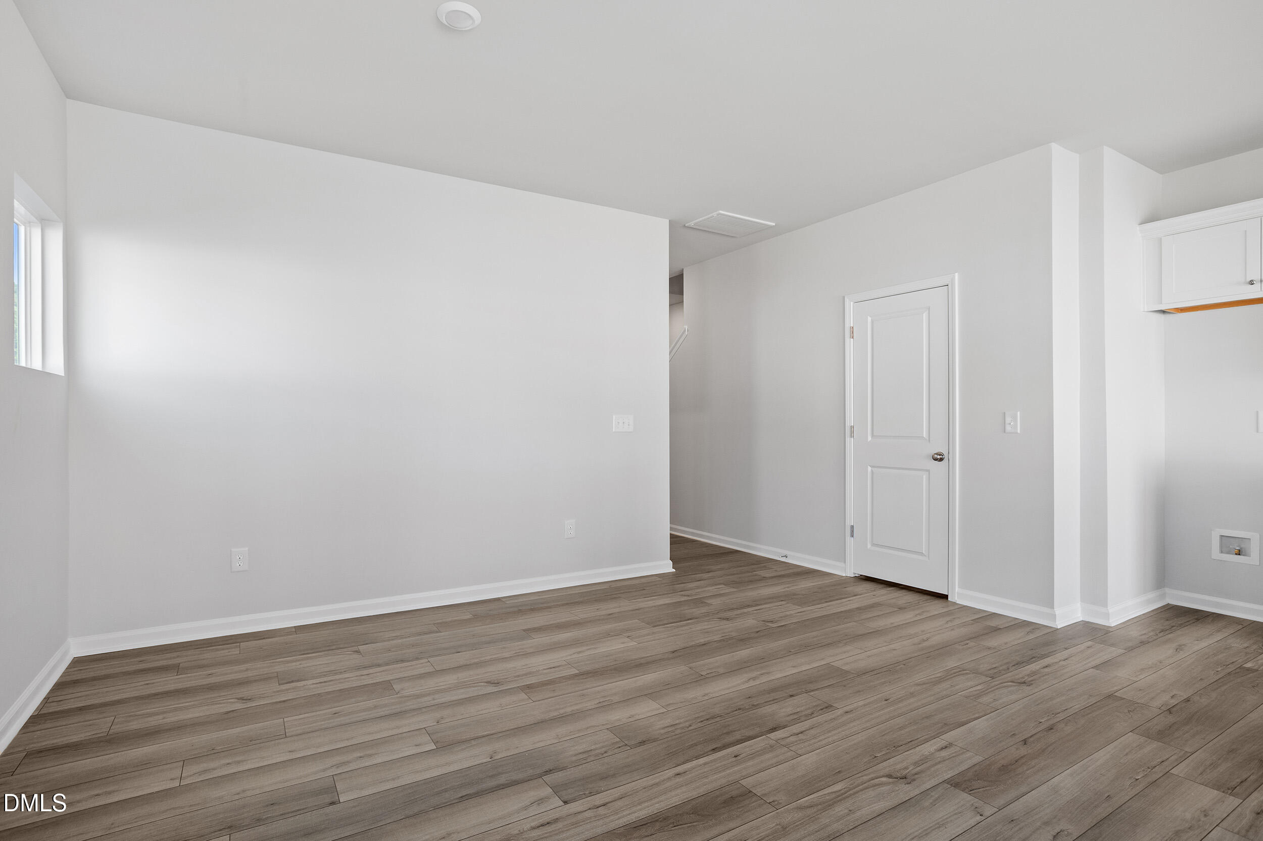 191 Powell Townes Way, Unit 319 Raleigh, NC 27603 - Photo 9 of 50 a view of an empty room with wooden floor