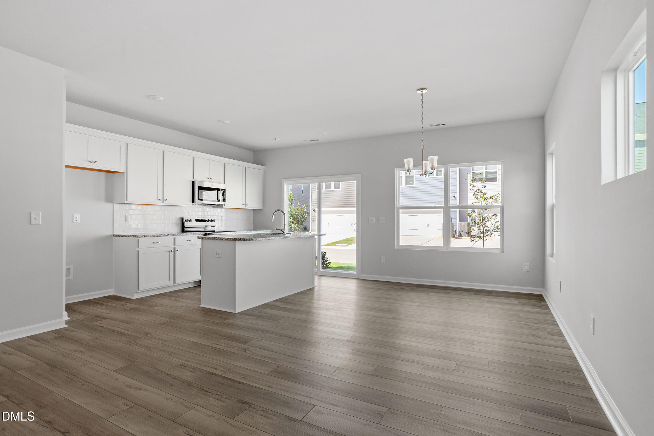 191 Powell Townes Way, Unit 319 Raleigh, NC 27603 - Photo 10 of 50 a view of kitchen with wooden floor electronic appliances and window