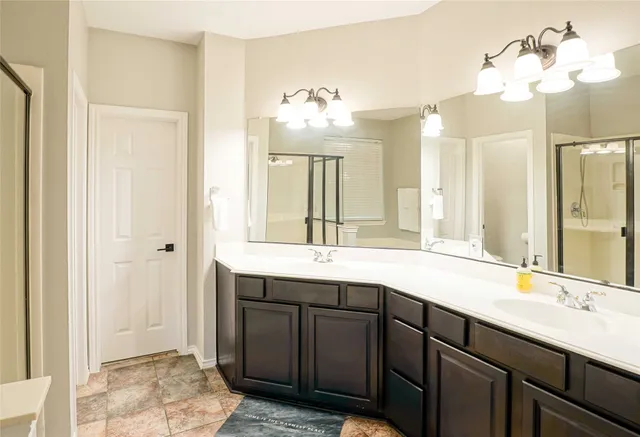 a bathroom with a double vanity sink and a mirror