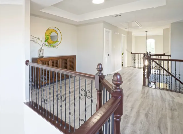 a view of a hallway with wooden floor