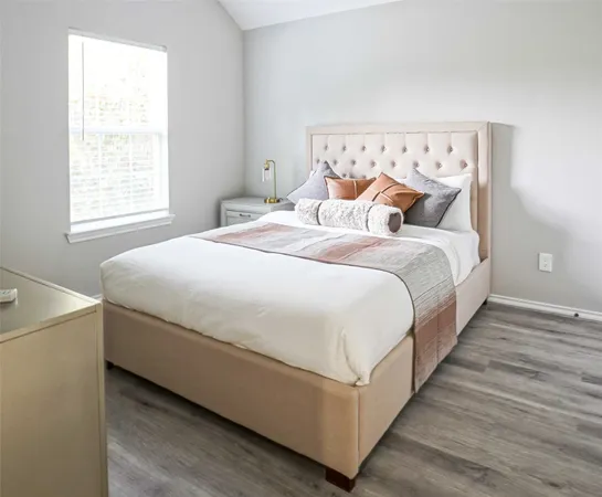 a bedroom with bed and a window