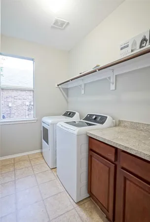 a utility room with sink dryer and washer