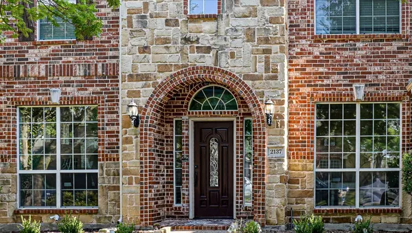 a front view of a house with a glass windows