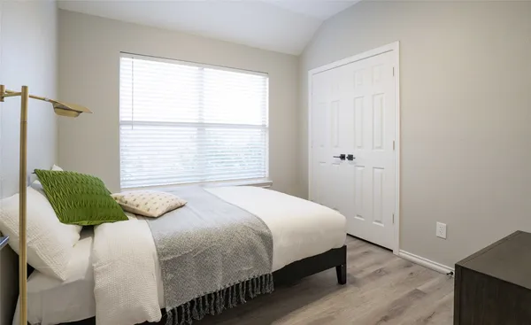 a bedroom with a bed and a window