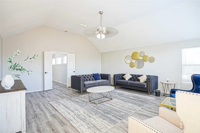 a living room with furniture and a chandelier