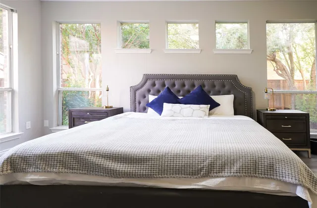 a bedroom with a bed and window