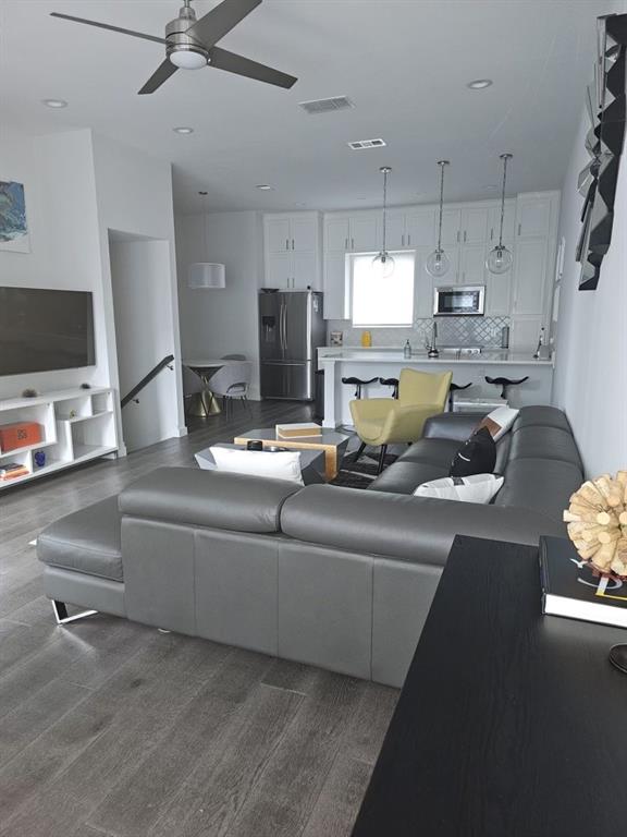 6004 Hudson Street, Unit 104 Dallas, TX 75206 - Photo 9 of 16 a living room with furniture and a flat screen tv