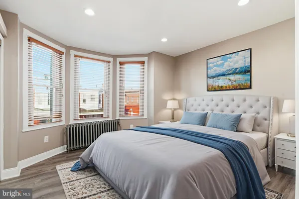 a bedroom with a large bed and a window